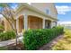 Brick porch with columns and lush green hedge at 10112 Haverhill Ridge Dr, Riverview, FL 33578