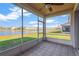 Relaxing screened porch overlooking a lake with views of other homes at 10112 Haverhill Ridge Dr, Riverview, FL 33578