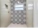 Stylish bathroom with patterned tile and a walk-in shower at 10971 90Th Ave, Seminole, FL 33772