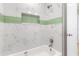 Updated bathroom with a walk-in shower and green tile accents at 10971 90Th Ave, Seminole, FL 33772