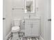Clean bathroom with white vanity and patterned floor tile at 10971 90Th Ave, Seminole, FL 33772