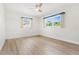 Bright bedroom with light wood flooring and dual windows at 10971 90Th Ave, Seminole, FL 33772