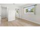 Light bedroom with wood floors and mirrored closet doors at 10971 90Th Ave, Seminole, FL 33772