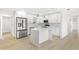 Modern kitchen with white cabinets, quartz countertops and island at 10971 90Th Ave, Seminole, FL 33772