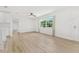 Open concept living area with large windows and light wood floors at 10971 90Th Ave, Seminole, FL 33772