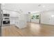 Open concept living room with kitchen island and light wood flooring at 10971 90Th Ave, Seminole, FL 33772