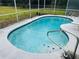 Kidney-shaped swimming pool with tiled coping at 12266 Folger St, Spring Hill, FL 34609