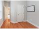 Bedroom with hardwood floors, closet, and access to hallway at 12311 Silton Peace Dr, Riverview, FL 33579