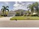 One-story house with light beige exterior, two-car garage, and lush landscaping at 12311 Silton Peace Dr, Riverview, FL 33579