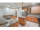 Island kitchen with granite countertops and wood cabinets at 12311 Silton Peace Dr, Riverview, FL 33579