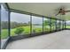 Large screened porch with pond view and ceiling fan at 12311 Silton Peace Dr, Riverview, FL 33579