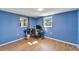 Home office with blue walls, wood floors, and a work station at 12620 3Rd Isle, Hudson, FL 34667