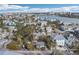 Aerial view of a beach town neighborhood showcasing various houses and waterfront at 128 Bay Plz, Treasure Island, FL 33706