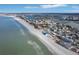 Aerial perspective showcasing coastline, beach, and beachfront properties at 128 Bay Plz, Treasure Island, FL 33706