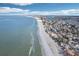 Aerial view of coastline, showing beach, ocean, and residential area at 128 Bay Plz, Treasure Island, FL 33706