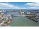 Wide aerial view of waterfront homes and bridge at 128 Bay Plz, Treasure Island, FL 33706