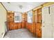 Unfinished room with wood paneling, ready for renovation at 128 Bay Plz, Treasure Island, FL 33706