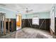 A room under renovation with exposed framing and flooring at 128 Bay Plz, Treasure Island, FL 33706