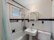 Clean bathroom with white tile, pedestal sink, and bathtub at 130 4Th N Ave # 414, St Petersburg, FL 33701