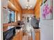 Bright galley kitchen, granite counters, wood cabinets, and modern appliances at 130 4Th N Ave # 414, St Petersburg, FL 33701