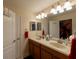 Double vanity bathroom with a large mirror and plenty of storage at 13458 Graham Yarden Dr, Riverview, FL 33579