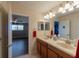 Double vanity bathroom with access to bedroom and additional storage at 13458 Graham Yarden Dr, Riverview, FL 33579