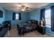 Bedroom with blue walls, double bed, and ceiling fan at 13458 Graham Yarden Dr, Riverview, FL 33579