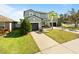 Two-story house with a green exterior, two-car garage, and palm tree at 13458 Graham Yarden Dr, Riverview, FL 33579