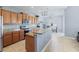Kitchen with granite countertops, wooden cabinets, and island at 13458 Graham Yarden Dr, Riverview, FL 33579