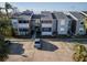Exterior view of condo building with parking and landscaping at 1400 Gandy N Blvd # 506, St Petersburg, FL 33702