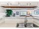 Bright kitchen features a double sink and views into the living area at 1400 Gandy N Blvd # 506, St Petersburg, FL 33702