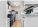 Small kitchen with stainless steel appliances and white cabinets at 1400 Gandy N Blvd # 506, St Petersburg, FL 33702