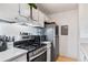 Efficient kitchen with stainless steel appliances and white cabinets at 1400 Gandy N Blvd # 506, St Petersburg, FL 33702
