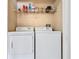 Laundry closet with washer, dryer, and storage shelf at 1400 Gandy N Blvd # 506, St Petersburg, FL 33702