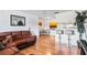 Bright living room with hardwood floors and a brown leather sectional sofa at 1400 Gandy N Blvd # 506, St Petersburg, FL 33702