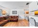 Living area with hardwood floors, brown sectional sofa, and kitchen bar at 1400 Gandy N Blvd # 506, St Petersburg, FL 33702