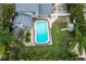 Aerial view of a backyard with pool and playset at 1534 Wexford N Dr, Palm Harbor, FL 34683