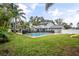 Large backyard featuring a beautiful pool and lush greenery at 1534 Wexford N Dr, Palm Harbor, FL 34683