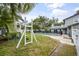 Spacious backyard with a playset and a view of the pool at 1534 Wexford N Dr, Palm Harbor, FL 34683