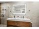 Elegant bathroom with double vanity, a large mirror, and marble tile at 1534 Wexford N Dr, Palm Harbor, FL 34683