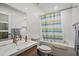 Clean bathroom with shower/tub combo, striped shower curtain, and modern vanity at 1534 Wexford N Dr, Palm Harbor, FL 34683