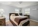 Bedroom with a double bed, dark brown dresser, and soft color palette at 1534 Wexford N Dr, Palm Harbor, FL 34683
