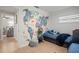 Bedroom with twin beds, world map mural, and view into another room at 1534 Wexford N Dr, Palm Harbor, FL 34683