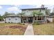 Two-story house with gray siding, palm trees, and a walkway at 1534 Wexford N Dr, Palm Harbor, FL 34683