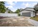 Attached garage with gray door and concrete driveway at 1534 Wexford N Dr, Palm Harbor, FL 34683