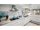 White kitchen with stainless steel appliances and wood cabinets at 1534 Wexford N Dr, Palm Harbor, FL 34683