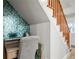 Convenient home office tucked under the stairs with custom wallpaper at 1534 Wexford N Dr, Palm Harbor, FL 34683