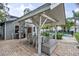 Covered patio features a dining setting and overlooks the pool at 1534 Wexford N Dr, Palm Harbor, FL 34683