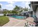 Relaxing pool area with a brick patio and safety fence at 1534 Wexford N Dr, Palm Harbor, FL 34683