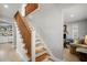 Wooden staircase with white risers and a wood railing at 1534 Wexford N Dr, Palm Harbor, FL 34683